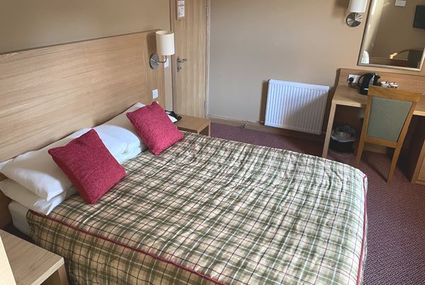 Double Bedroom with chair and desk in one of Loch Achray's Hotels many rooms
