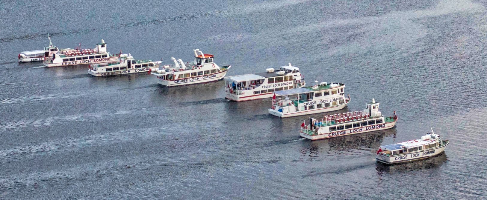 Superb photo featuring tghe cruise on Loch lomond and their entire fleet