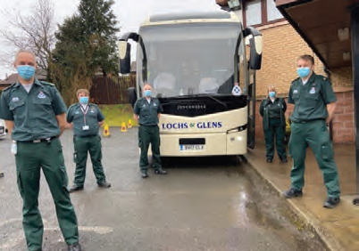 Scottish
Ambulance Service pose for a photo outside Lochs and Glens coach